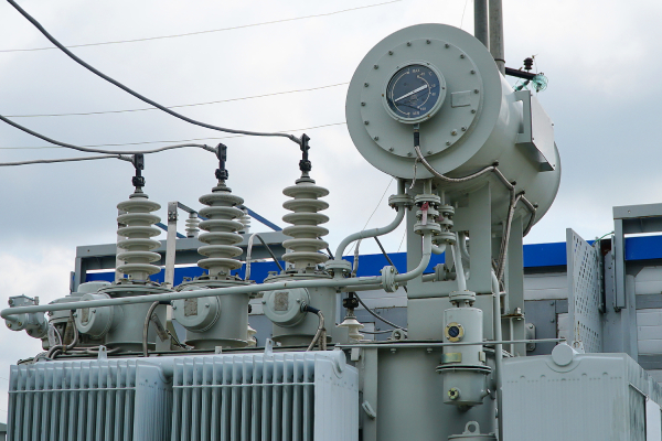 Why are distribution transformers important in the power grid